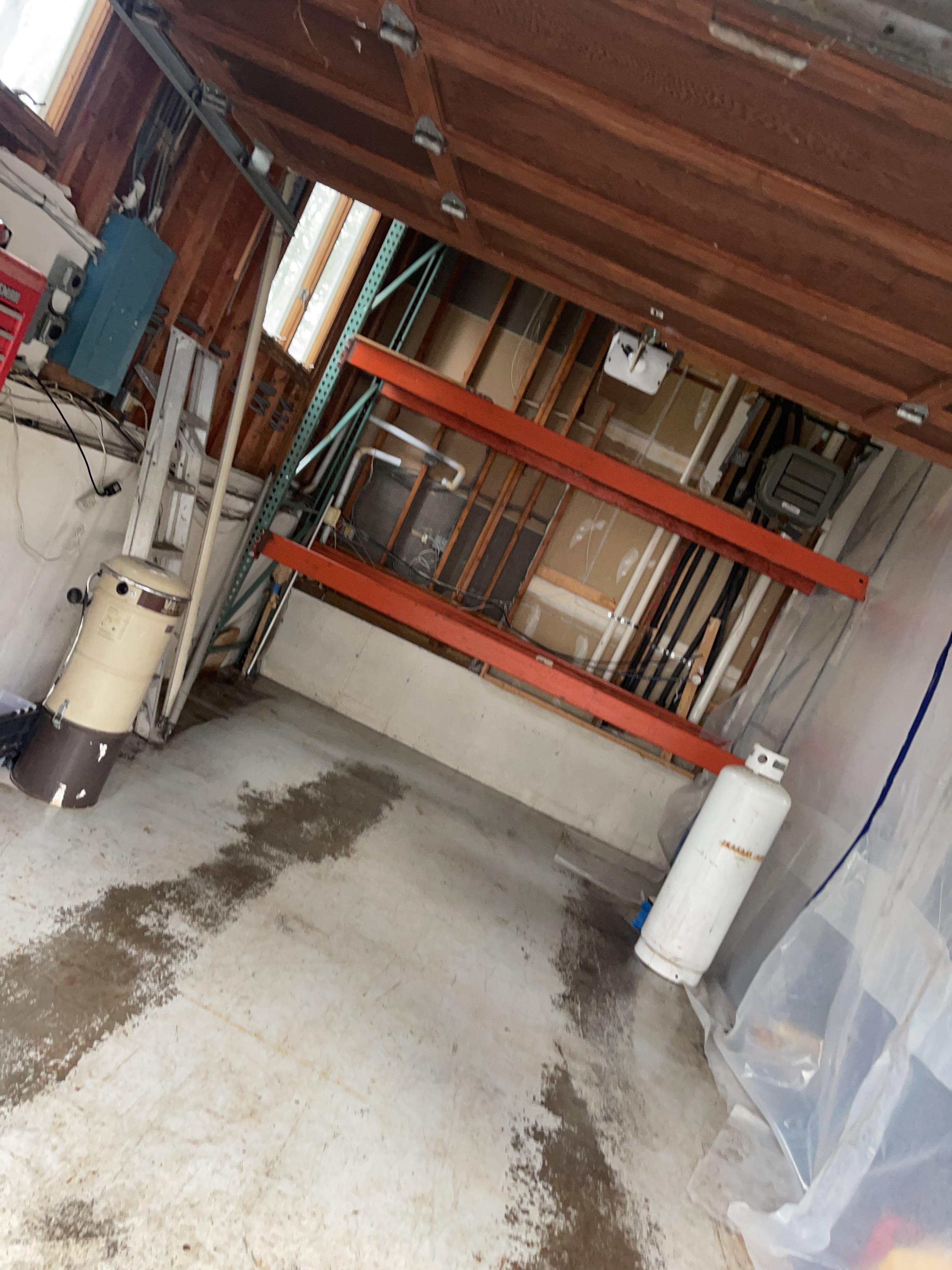 Garage cleared, cleaned and disinfected. Wet drywall removed.